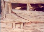 Bluff Fort -- The portion of the Barton cabin which is not restored provides a glimpse of the work involved in securing adjoining logs together with pins. Lamont Crabtree Photo